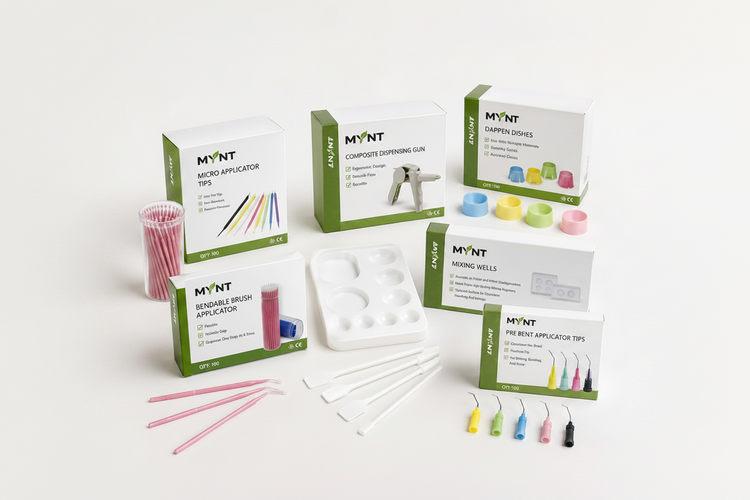 MYNT cosmetic dentistry products displayed on a clean white background, featuring various boxes of dental tools, applicator tips, mixing wells, and a composite dispensing gun.