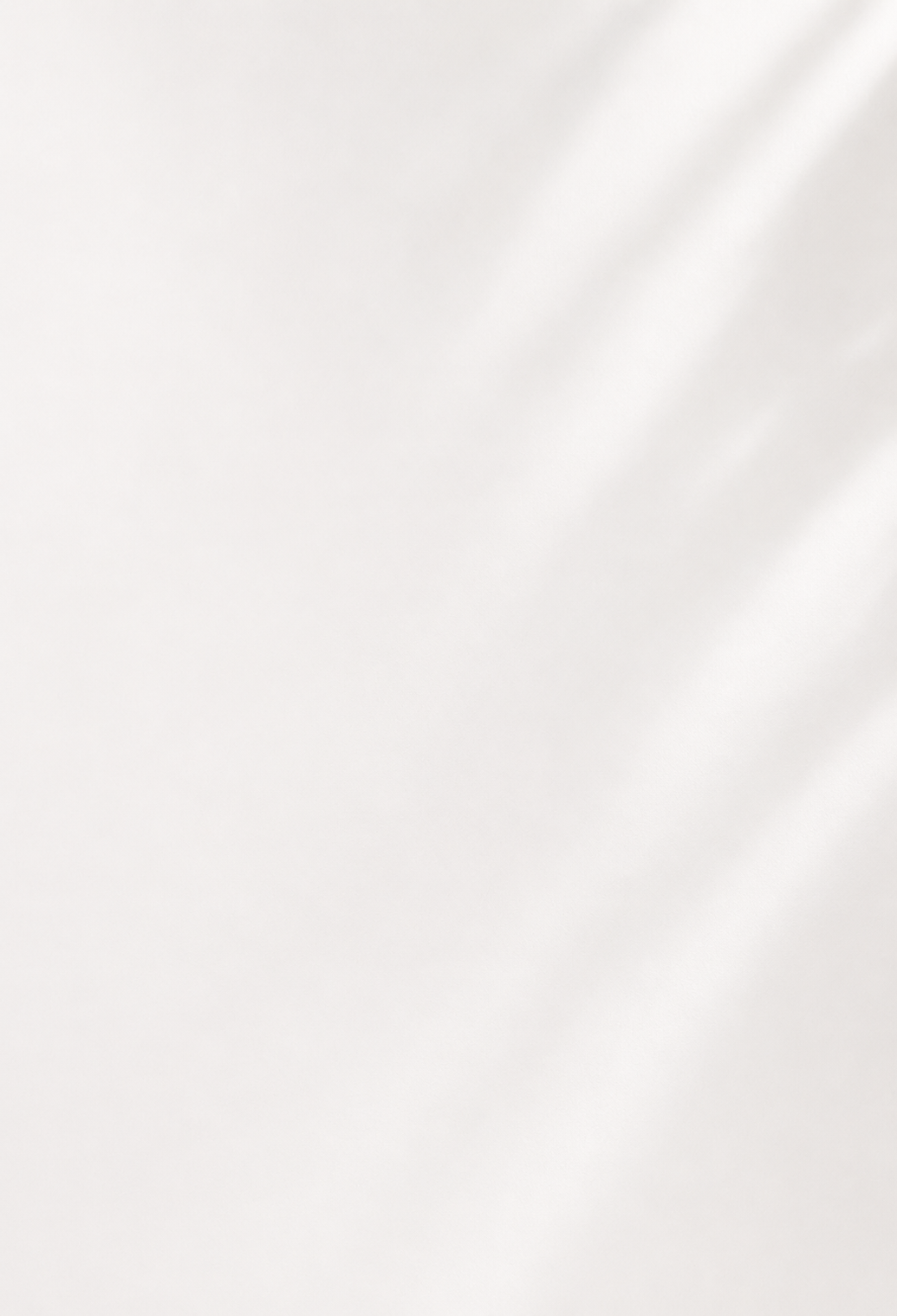 A close-up of a soft, off-white fabric with a subtle sheen and gentle diagonal light reflections.